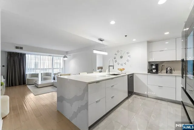 a large white kitchen with a large window