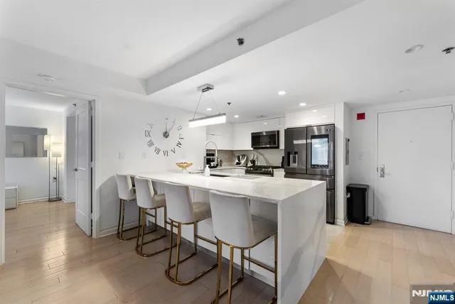 a kitchen with a dining table chairs and white appliances