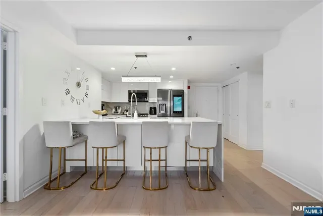 a kitchen with a table chairs refrigerator and cabinets