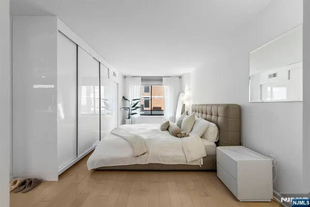 a bedroom with a bed couch and a window