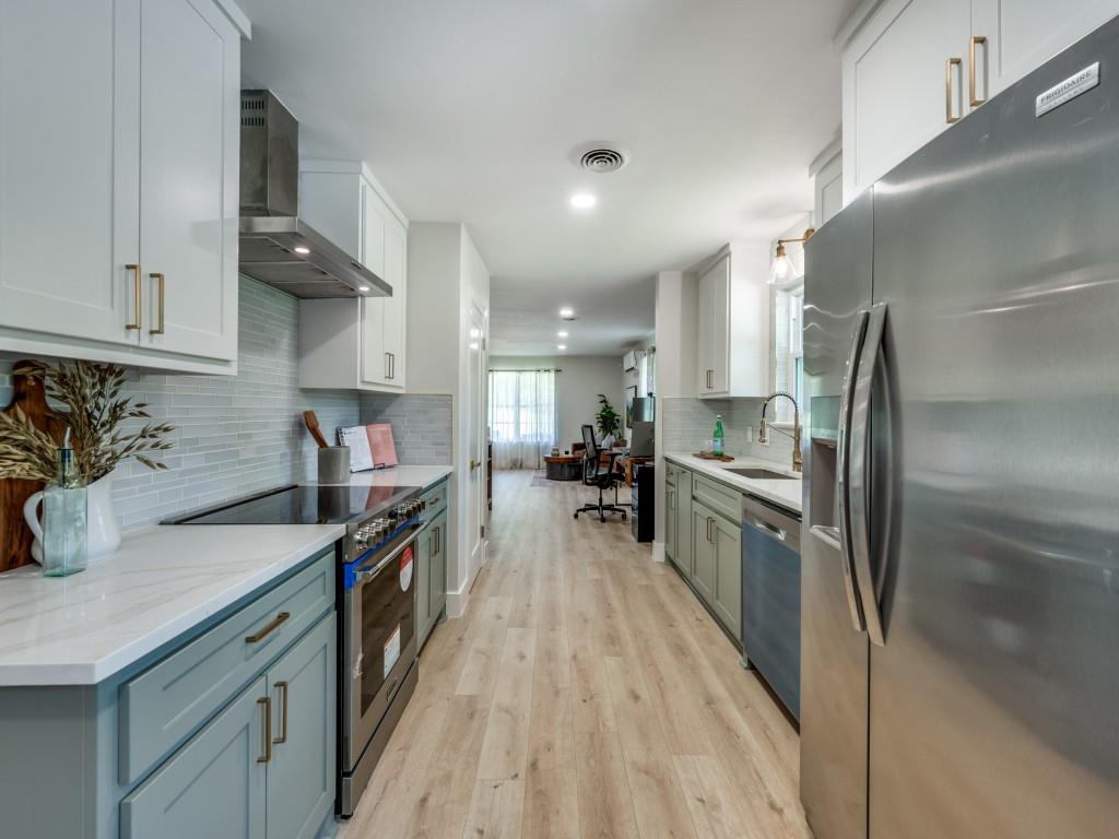 3406 Springwood Lane Dallas, TX 75233 - Photo 12 of 36 a kitchen with granite countertop a sink counter top space appliances and cabinets