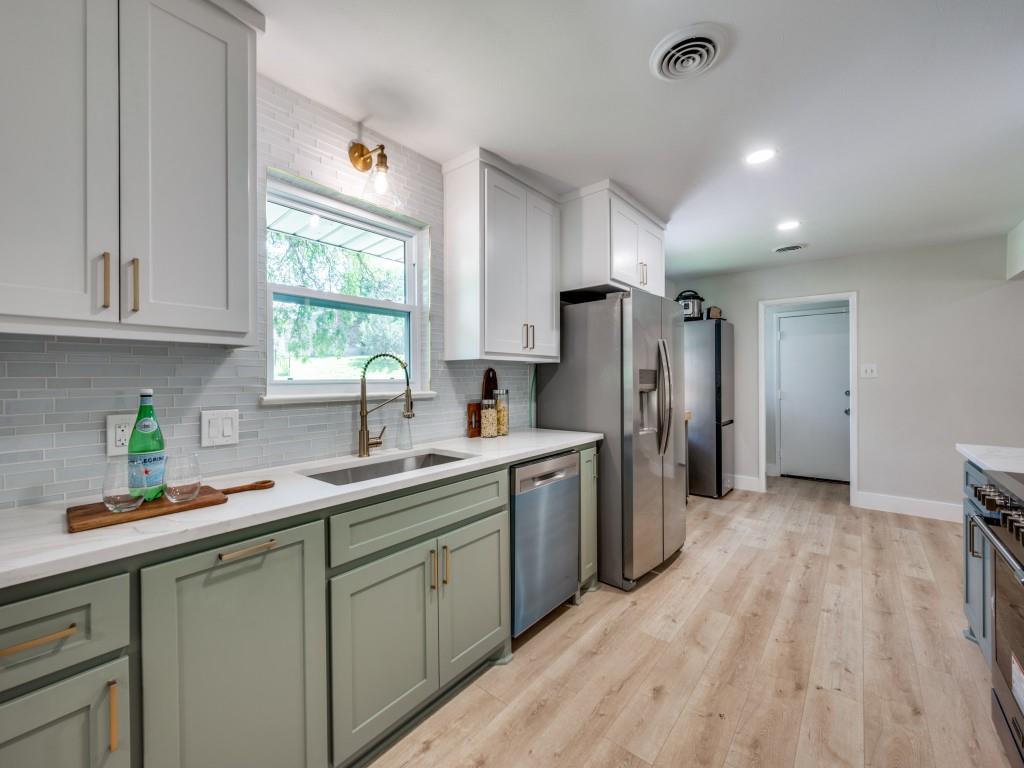 3406 Springwood Lane Dallas, TX 75233 - Photo 13 of 36 a kitchen with a sink a refrigerator and window