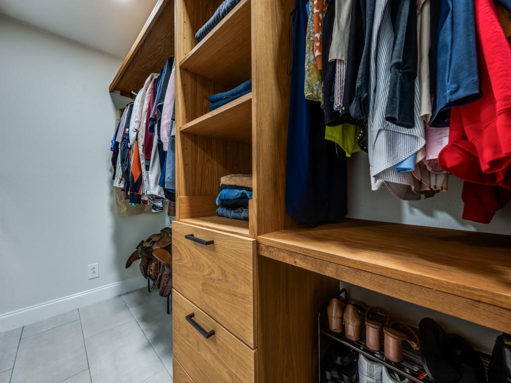 3406 Springwood Lane Dallas, TX 75233 - Photo 27 of 36 a view of walk in closet with clothes and shoes