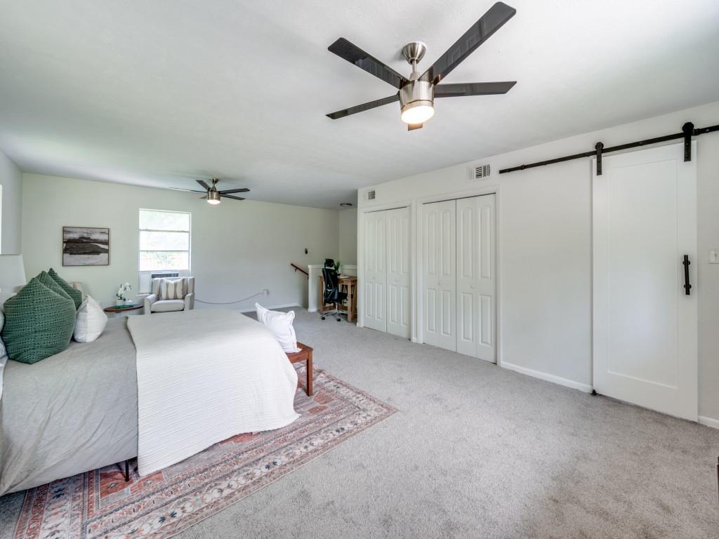 3406 Springwood Lane Dallas, TX 75233 - Photo 29 of 36 a bed room with a bed and a chandelier