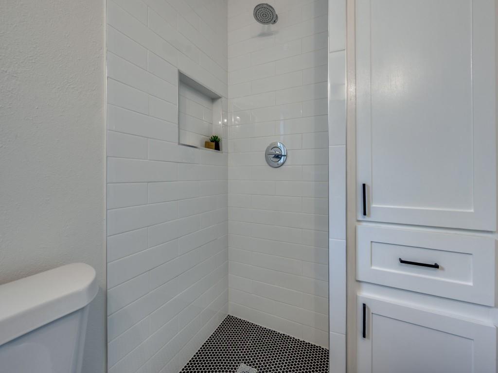3406 Springwood Lane Dallas, TX 75233 - Photo 32 of 36 a bathroom with a shower and toilet