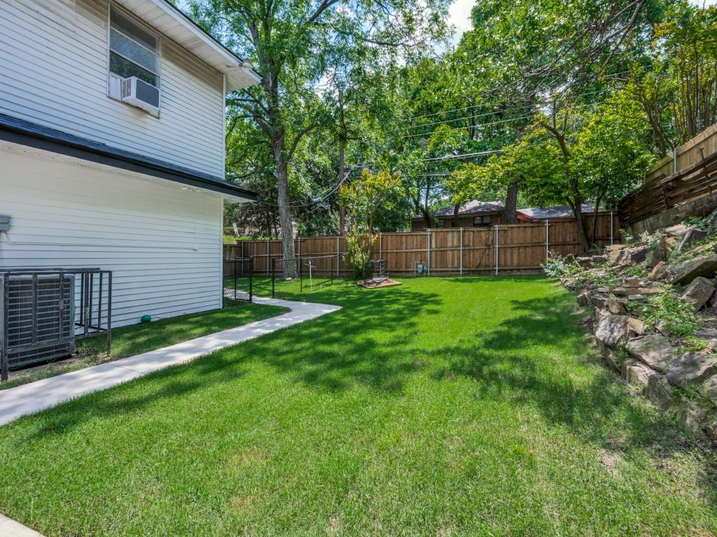 3406 Springwood Lane Dallas, TX 75233 - Photo 34 of 36 a view of a backyard with a small cabin and a chair
