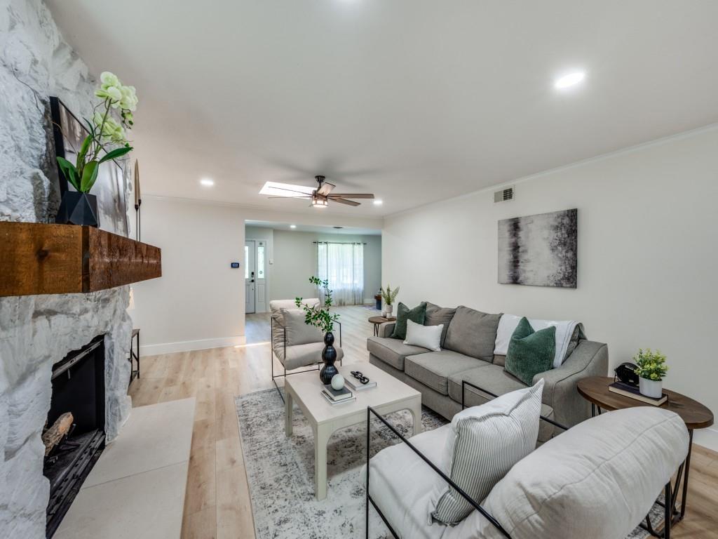3406 Springwood Lane Dallas, TX 75233 - Photo 7 of 36 a living room with furniture a fireplace and a potted plant