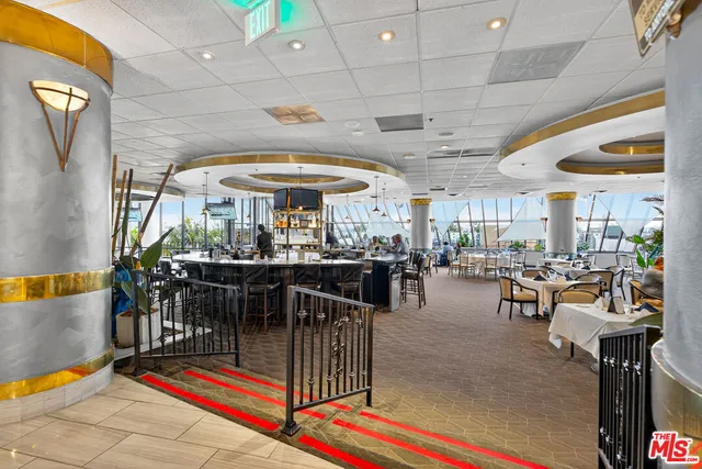 a view of a dining hall with many windows