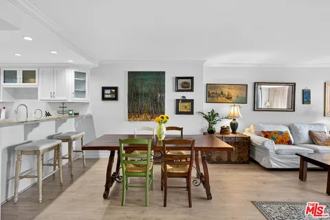 a living room with furniture wooden floor and a table