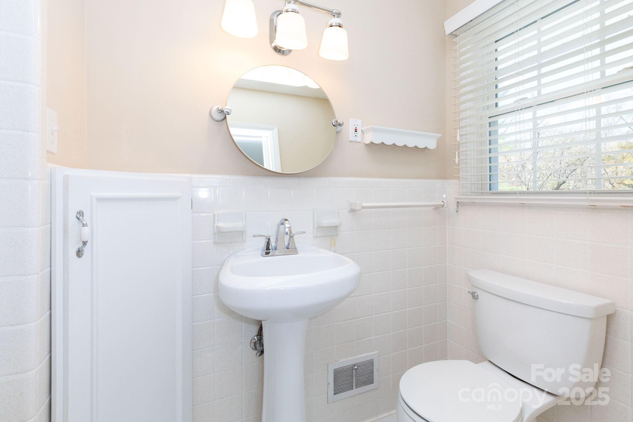 66 Gibson Road Asheville, NC 28804 - Photo 11 of 26 a bathroom with a toilet sink and mirror