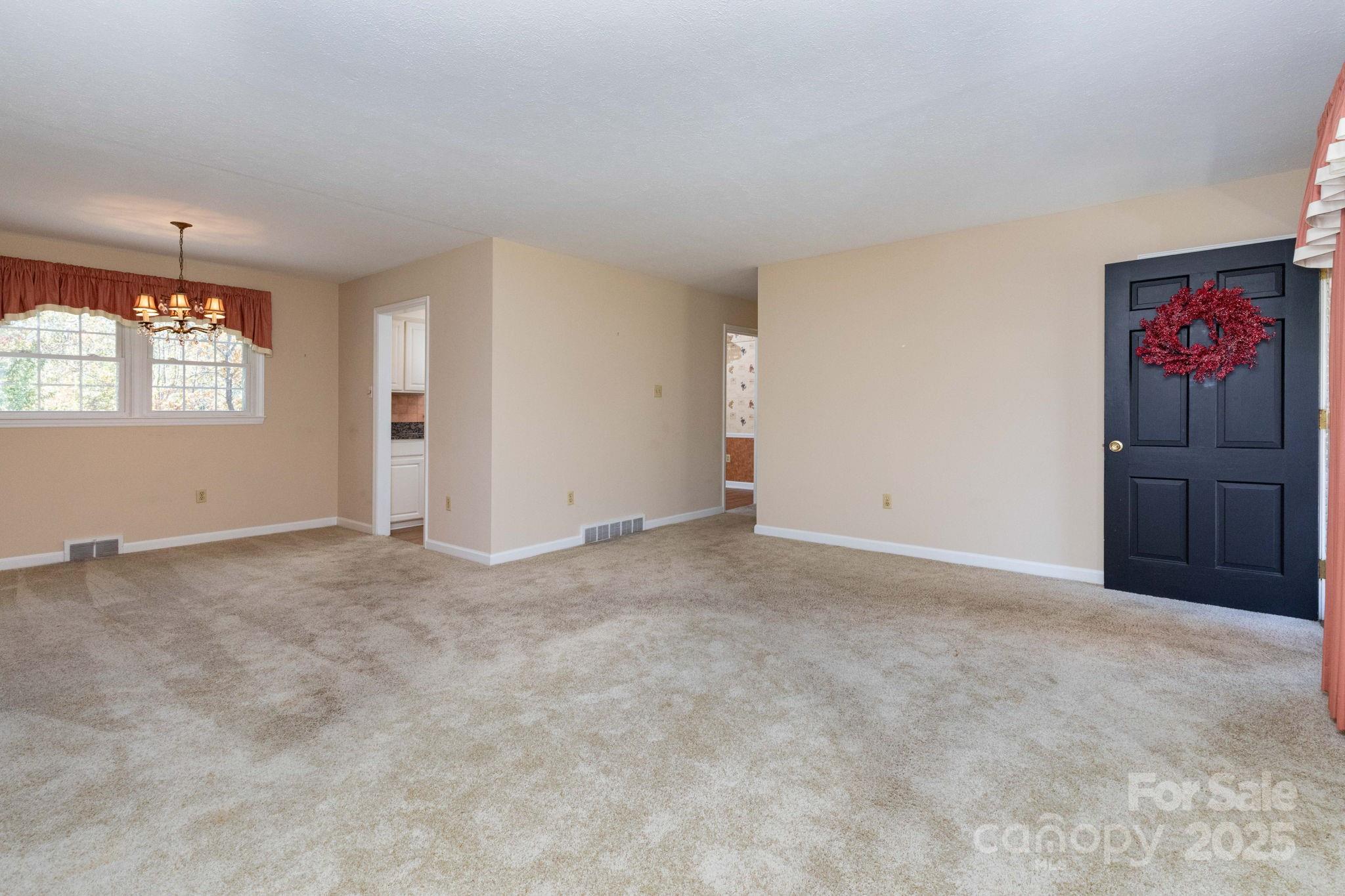 66 Gibson Road Asheville, NC 28804 - Photo 2 of 26 an empty room with windows and cabinet
