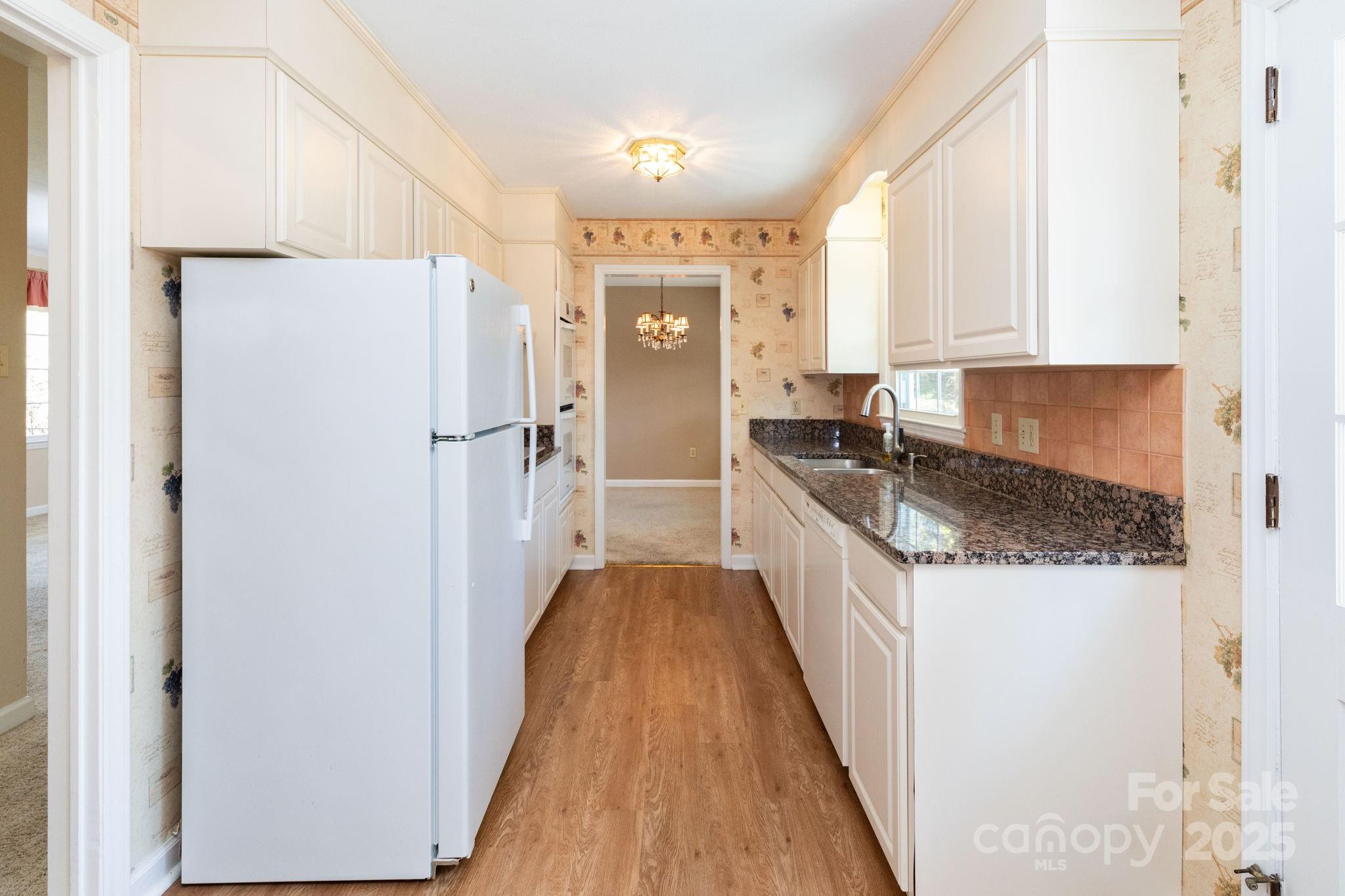 66 Gibson Road Asheville, NC 28804 - Photo 7 of 26 a kitchen with a refrigerator a stove top oven and cabinets
