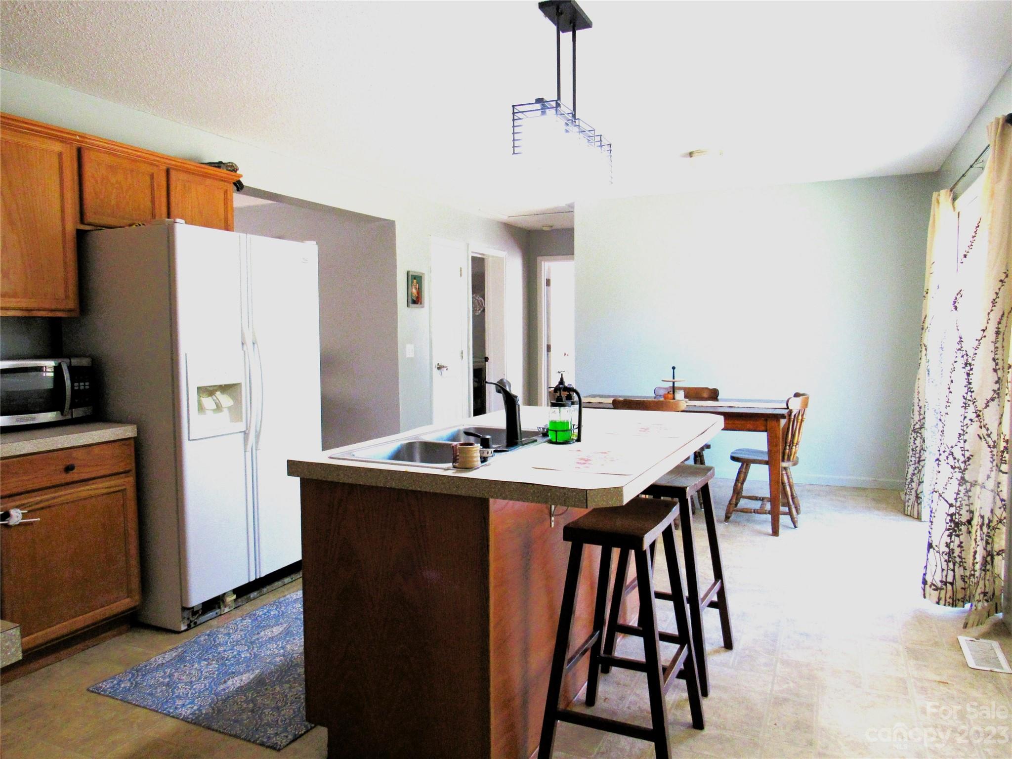 4116 Big Level Road Mill Spring, NC 28756 - Photo 8 of 23 a view of a kitchen with a table and chairs