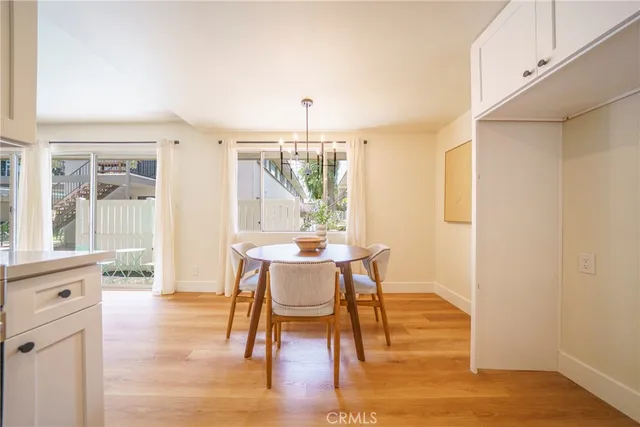 a view of a dining room with furniture window and wooden floor