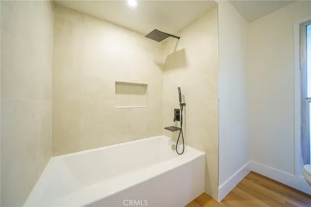a bathroom with a bathtub and a shower