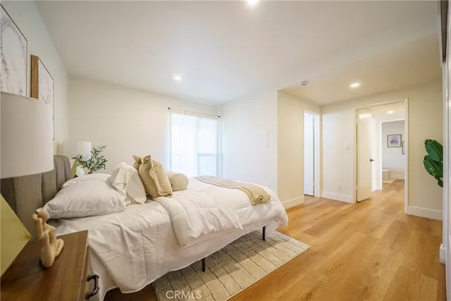 a bedroom with a bed and a view of kitchen