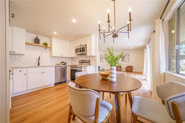 a kitchen with kitchen island a table and chairs in it