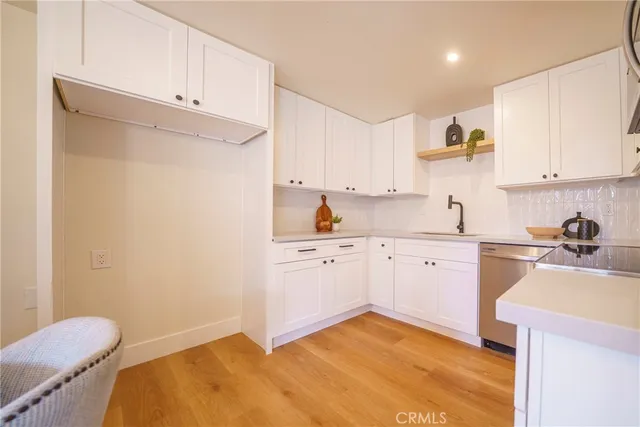 a kitchen with a sink cabinets and appliances