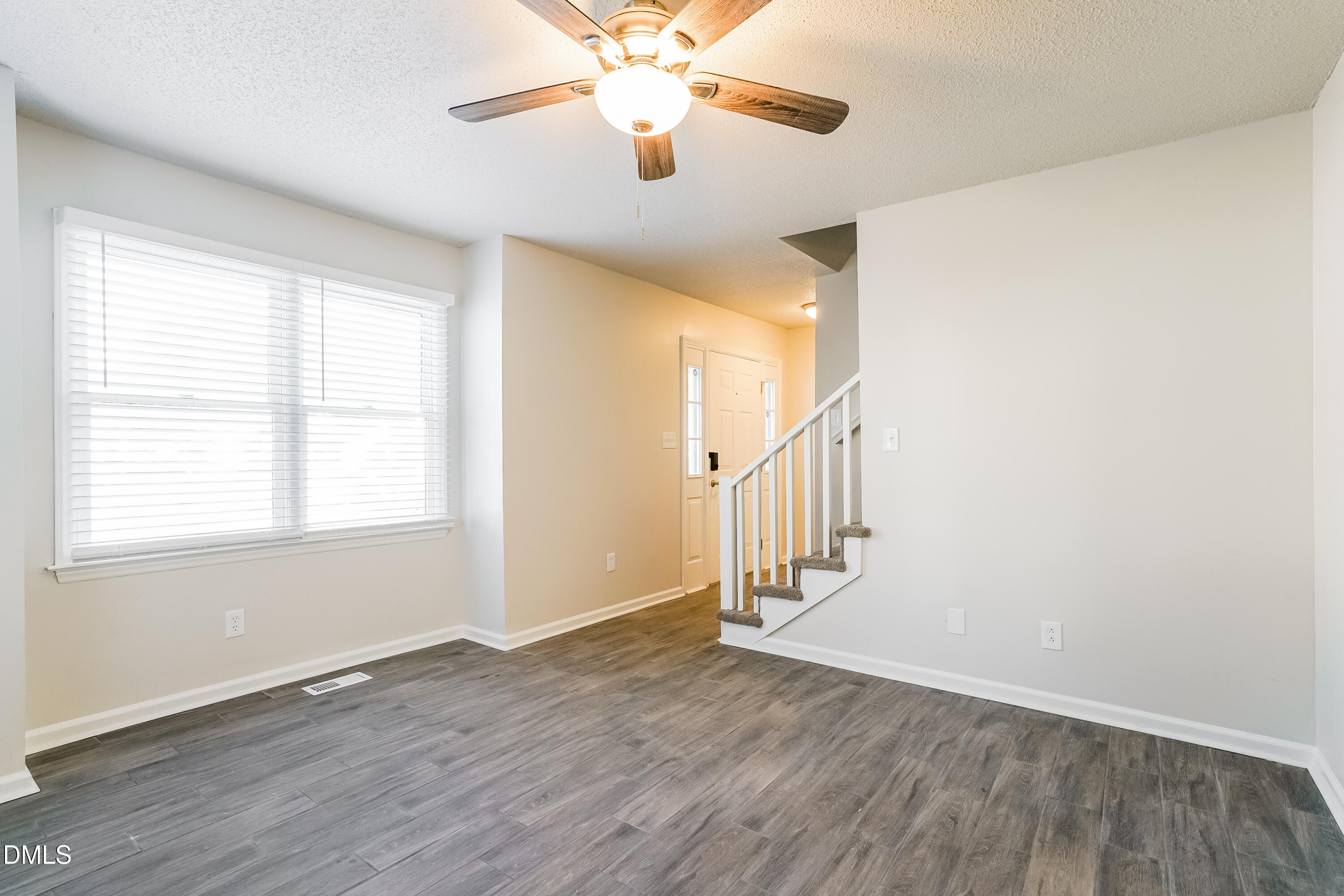 849 Rawls Drive Raleigh, NC 27610 - Photo 2 of 18 a view of an entryway with wooden floor and a chandelier fan
