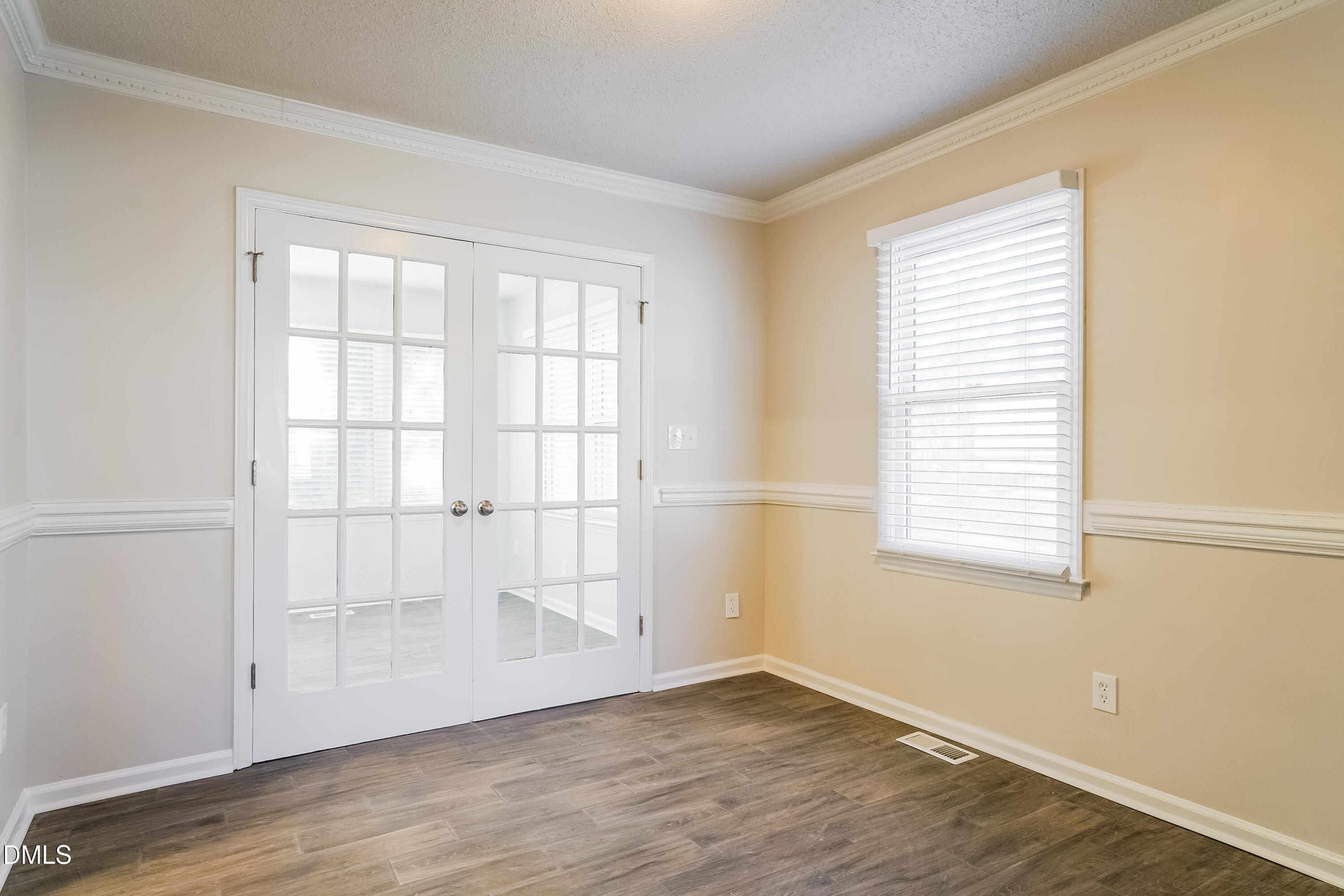 849 Rawls Drive Raleigh, NC 27610 - Photo 4 of 18 an empty room with wooden floor and windows