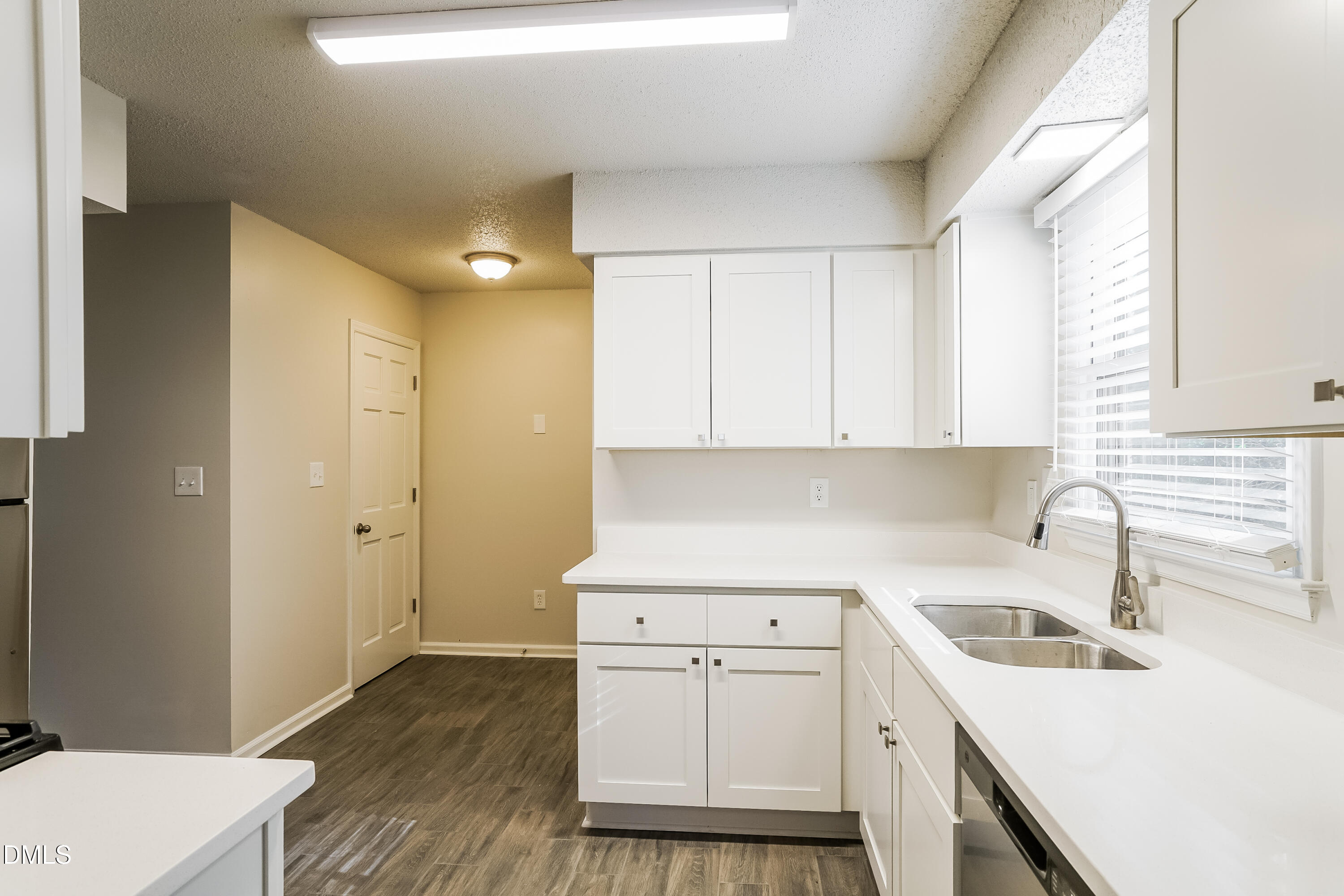 849 Rawls Drive Raleigh, NC 27610 - Photo 7 of 18 a kitchen with a sink a stove and cabinets