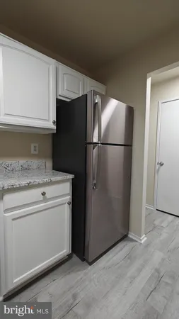 a kitchen with a refrigerator and a stove