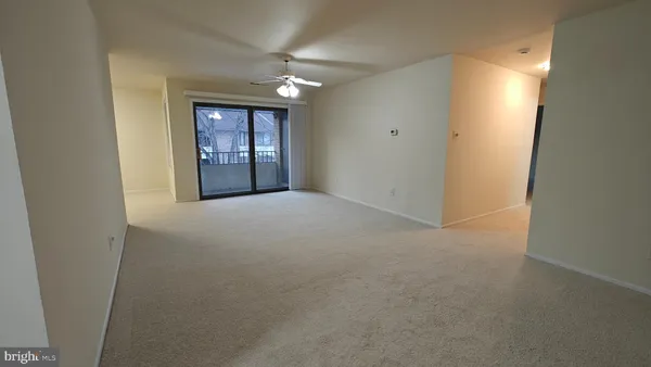 an empty room with windows and cabinet