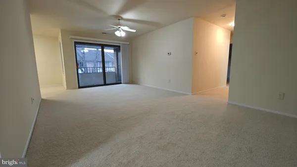 an empty room with windows and cabinet