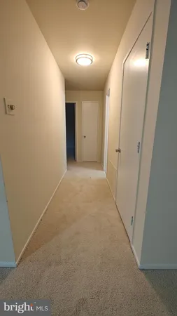 a view of hallway with an empty room