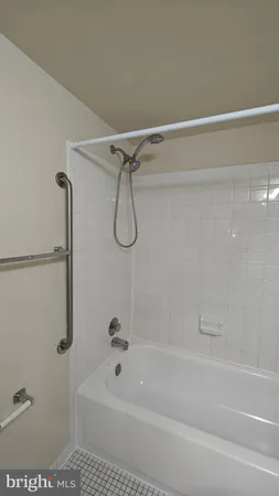 a bathroom with a bath tub with a shower