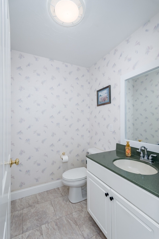 6 Nates Way Rutland, MA 01543 - Photo 13 of 31 a bathroom with a granite countertop toilet a sink and mirror