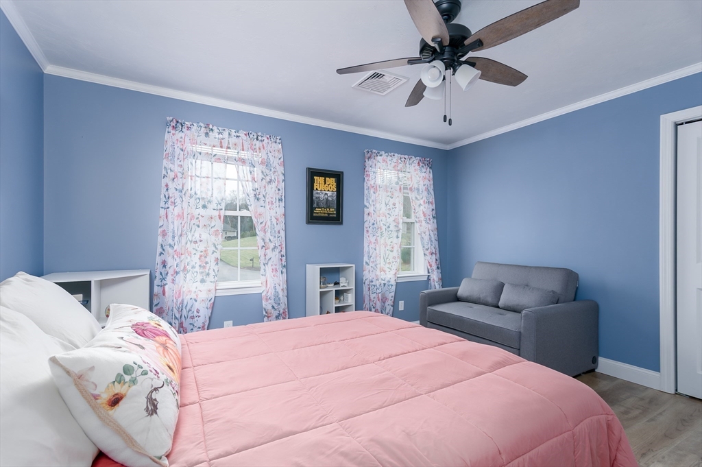 6 Nates Way Rutland, MA 01543 - Photo 17 of 31 a bedroom with a bed couches and a chandelier