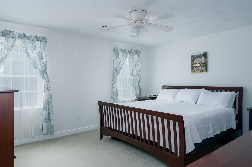 6 Nates Way Rutland, MA 01543 - Photo 21 of 31 a bedroom with a bed and a chandelier