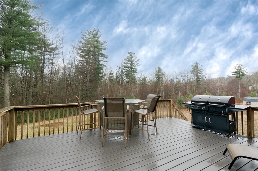 6 Nates Way Rutland, MA 01543 - Photo 30 of 31 a view of a roof deck with table and chairs a barbeque with wooden floor and fence