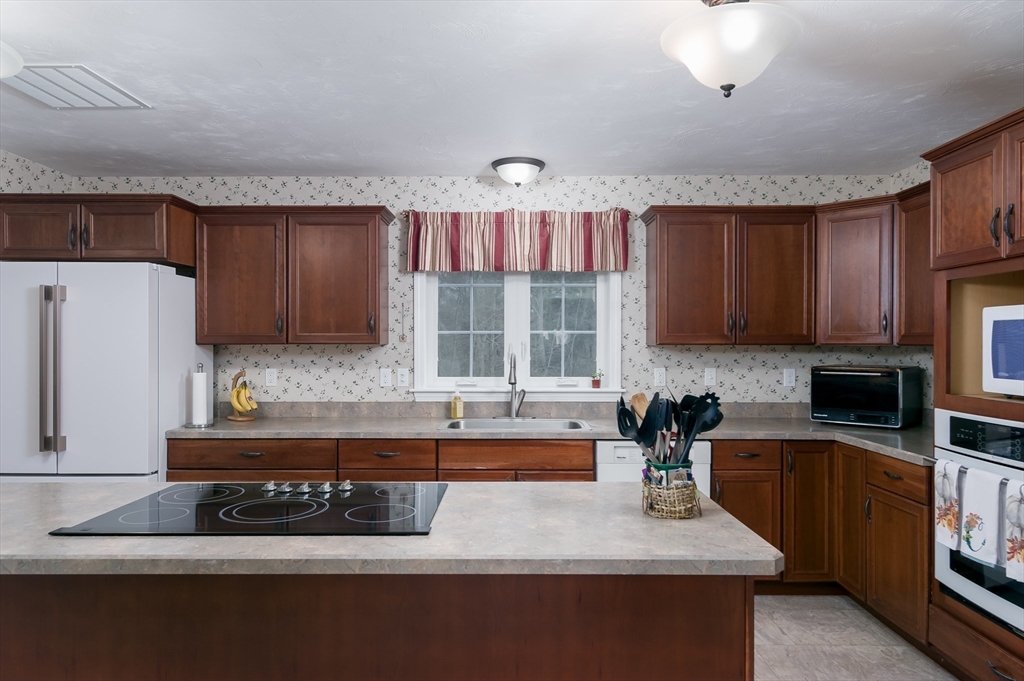6 Nates Way Rutland, MA 01543 - Photo 4 of 31 a kitchen with kitchen island granite countertop a sink a counter top space appliances and cabinets