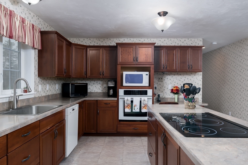 6 Nates Way Rutland, MA 01543 - Photo 5 of 31 a kitchen with stainless steel appliances granite countertop a stove sink and cabinets