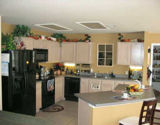 907 Swallow Ridge Cove Pflugerville, TX 78660 - Photo 1 of 1 a kitchen with granite countertop a sink stove and refrigerator