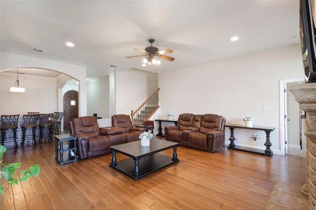 a living room with furniture and wooden floor