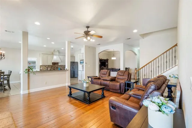 a living room with furniture and kitchen view