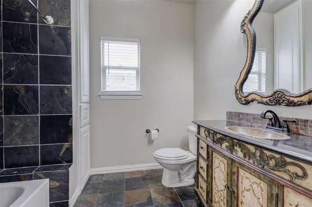 a bathroom with a sink a toilet and a mirror