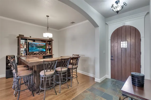 a view of a dining room with furniture and a chandelier