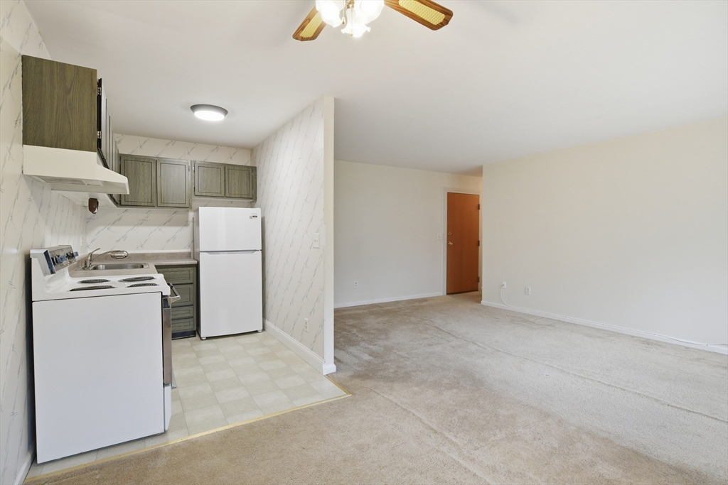 74 Barrett Street, Unit 308 Northampton, MA 01060 - Photo 5 of 22 a view of a kitchen with a sink and a refrigerator