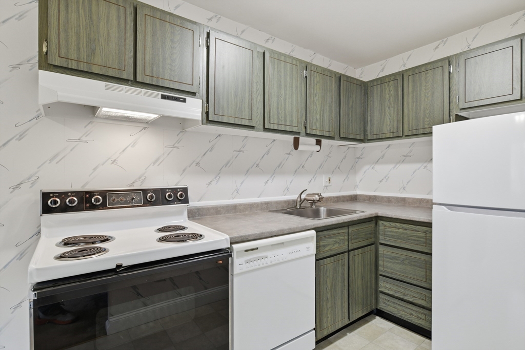 74 Barrett Street, Unit 308 Northampton, MA 01060 - Photo 7 of 22 a kitchen with a sink stove and cabinets