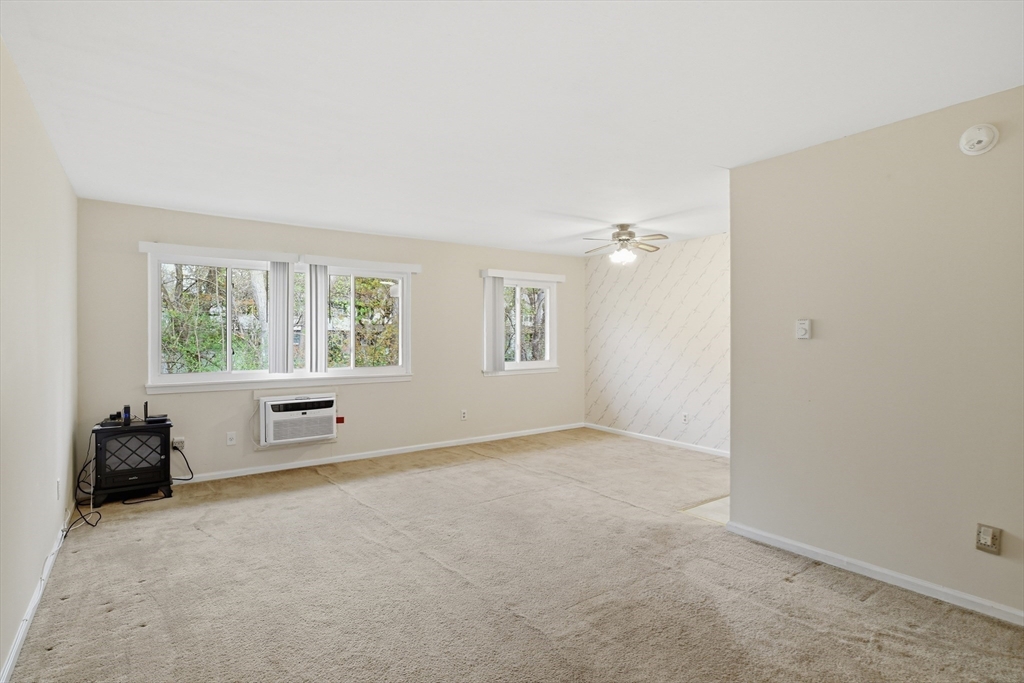 74 Barrett Street, Unit 308 Northampton, MA 01060 - Photo 8 of 22 an empty room with windows and closet