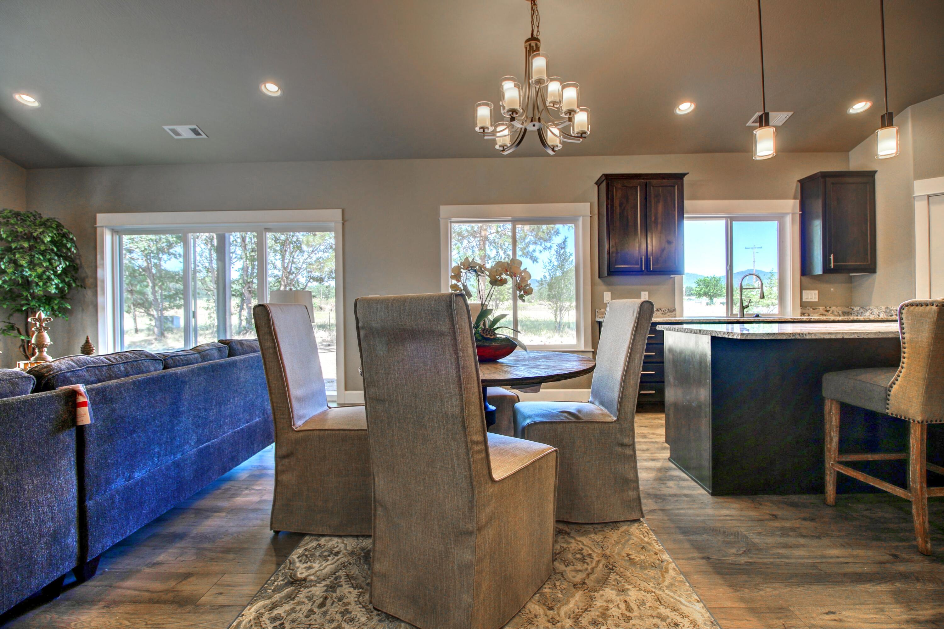 3217 Sams Valley Road White City, OR 97503 - Photo 12 of 40 a view of a dining room with furniture and a chandelier