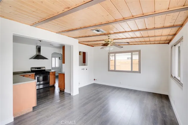 a view of a big room with wooden floor and cabinets