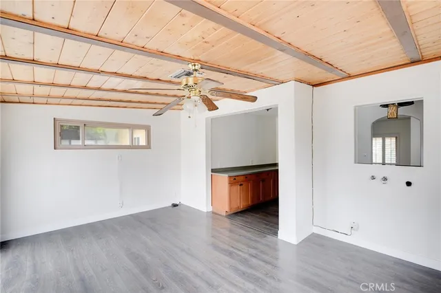 a view of a room with wooden floor
