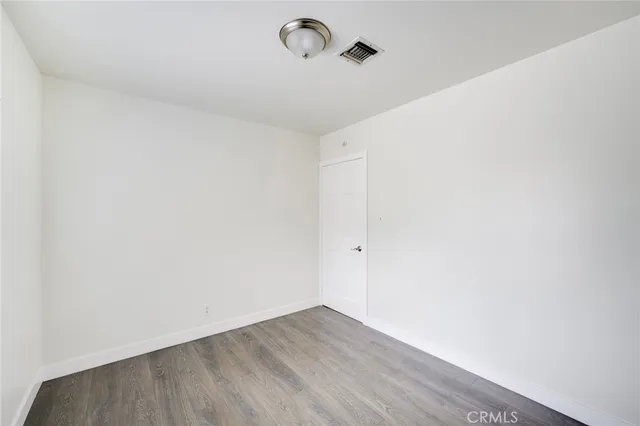 a view of a room with wooden floor and windows