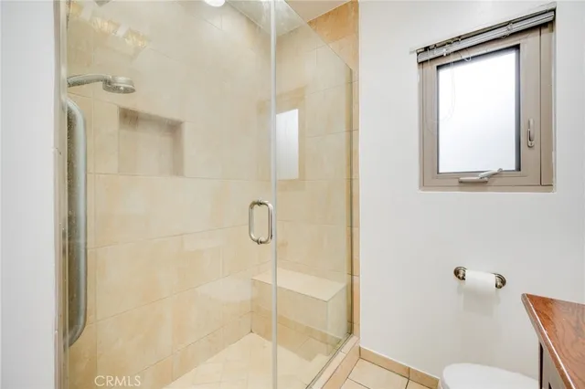 a view of a room with a window and a ceiling fan