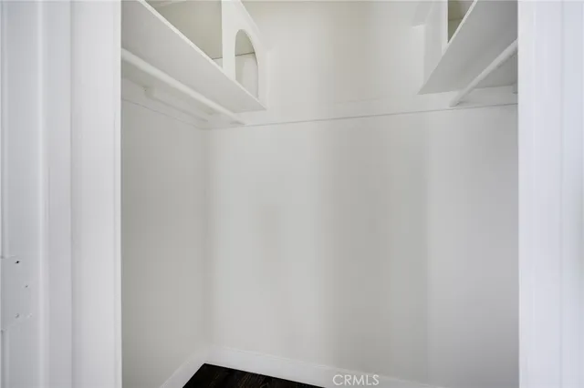 a sidewalk with a building in the background